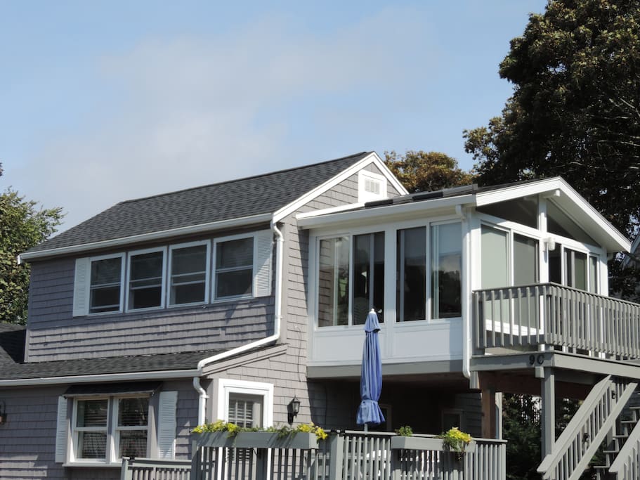 2nd floor cottage condo with ocean views and 3 season room and deck.