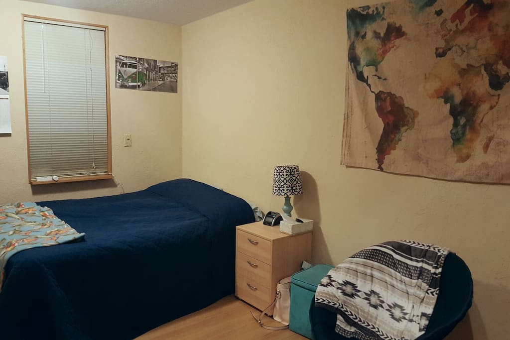 Large bedroom with two windows overlooking the backyard