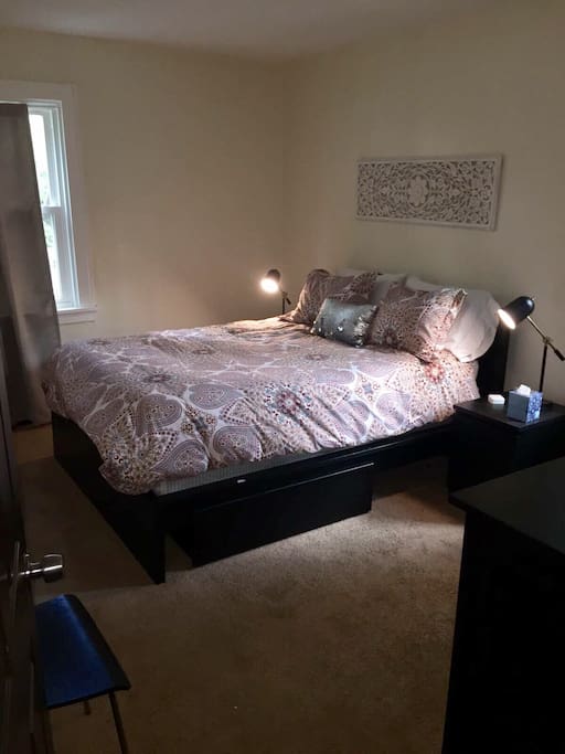 Bedroom with queen size mattress (IKEA Sultan) with plenty of under bed drawer space and a large dresser for use on longer stays! Fresh white linens and down comforter with duvet for a comfortable sleep!