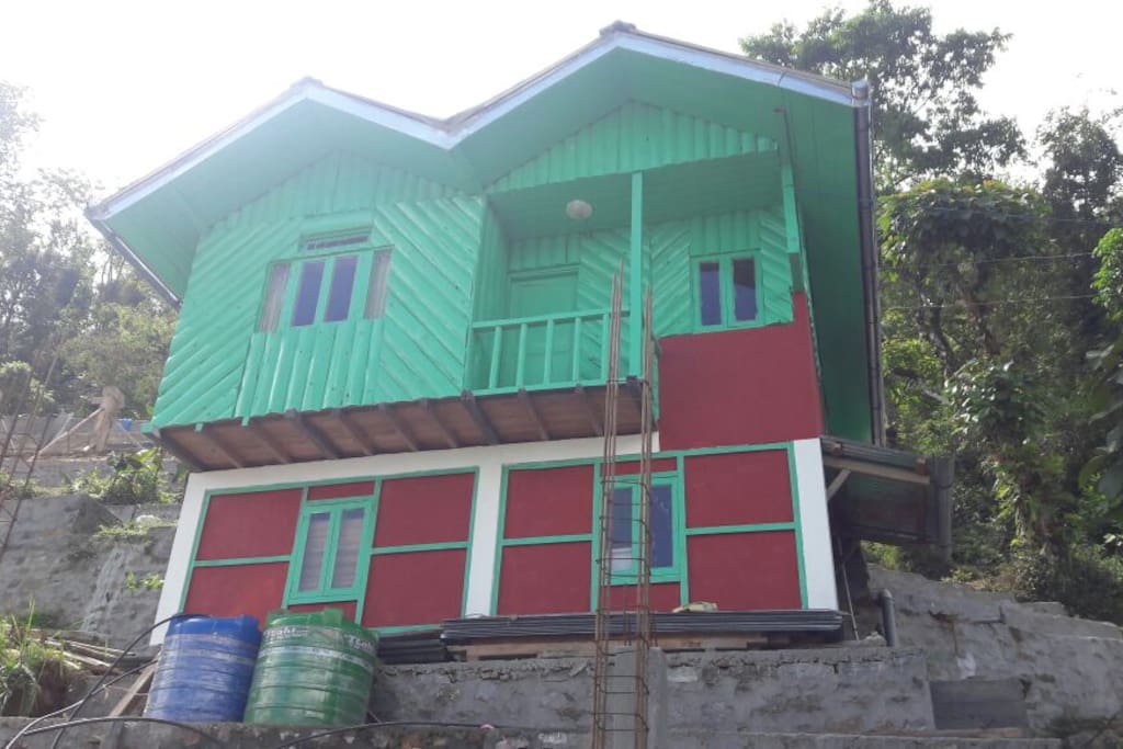 The wooden cottage with new paint, with local colors