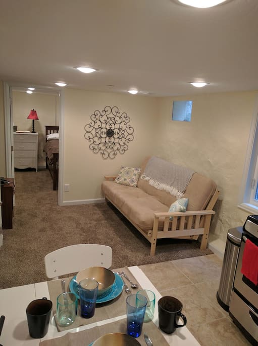 Here you can see the entrance to the bedroom, as well as the futon for lounging to watch TV (no cable at this time, however) or curling up to read a book.
