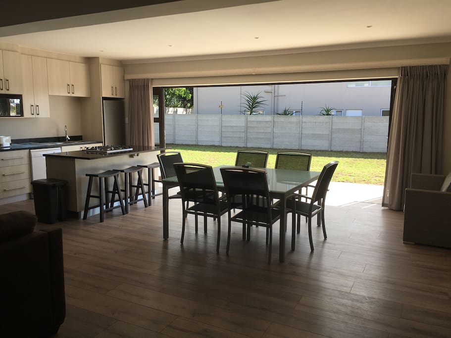 Kitchen and spacious dining room table with open stacker doors