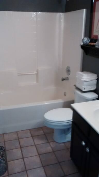 Bathroom is a small full with tub/shower