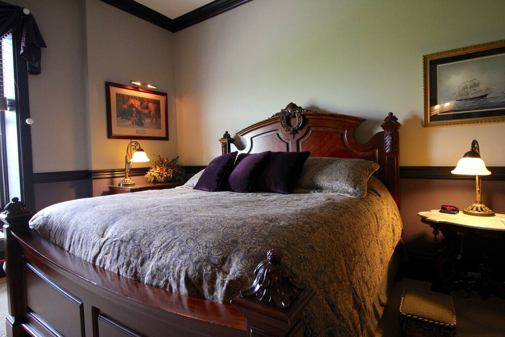 The Library Room
Stately elegance marks this Library with a sense of historic class. King bed surrounded by leather wing back chairs, high secretary's desk, Tiffany lamps and classic books. Sleep like a statesman in this presidential suite with private bath and bonus sun room with day bed.
Fits 3 people max