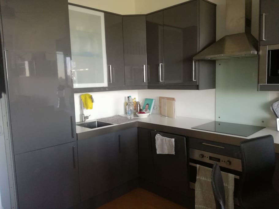The dark-grey kitchen is equipped with all the amenities you might need. There is a coffee maker for your early morning coffee, a blender and a microwave/oven.