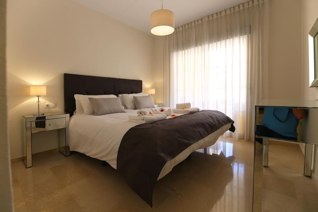 Comfortable master bedroom with terrace access