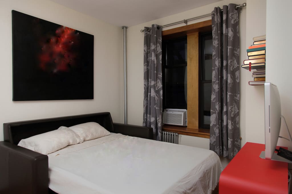 Bedroom with sofa opened to a comfy queen size bed from American Leather/Design Within Reach.