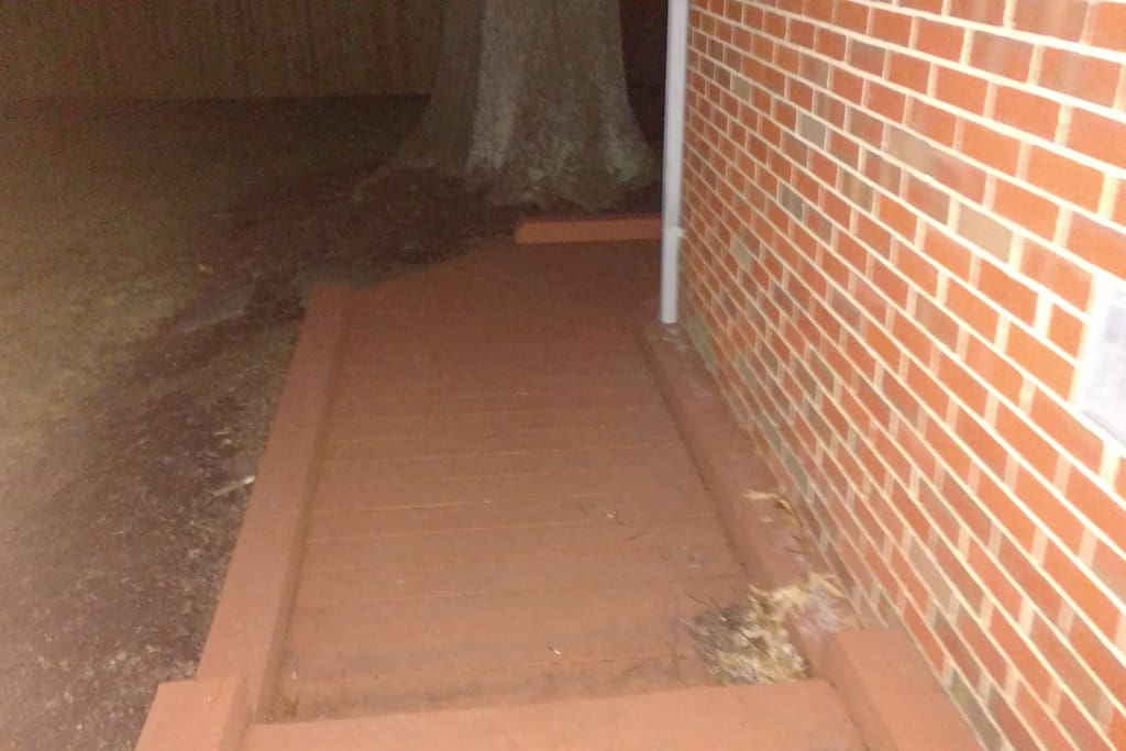Wooden walkway leading to the basement apartment.