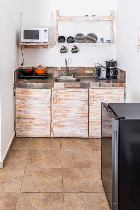 Kitchenette with microwave, mini fridge, electric stovetop, coffee maker and toaster