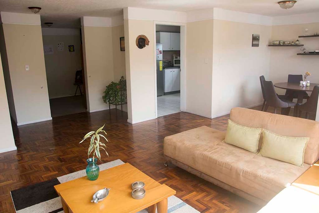Ample and cozy living room with a view to the Pichincha Volcano.