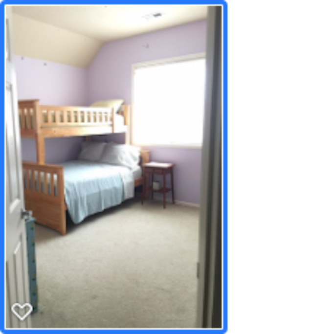Room has a single over double bunk bed