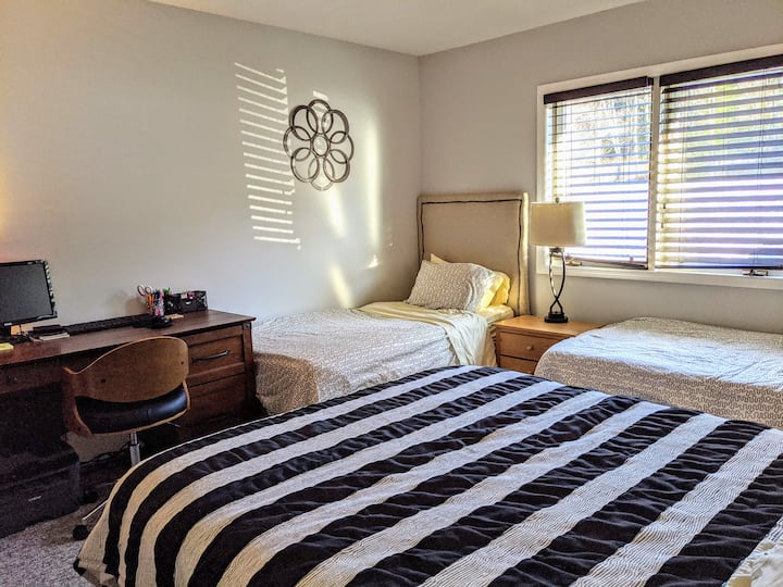 Large bedroom with a queen bed and 2 twin beds.   As well as a great work space.