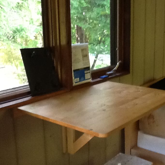 Small fold down table overlooking picnic area.