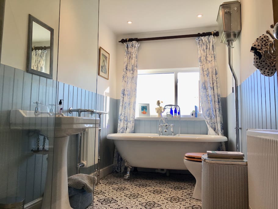 Romantic bathroom with roll top bath