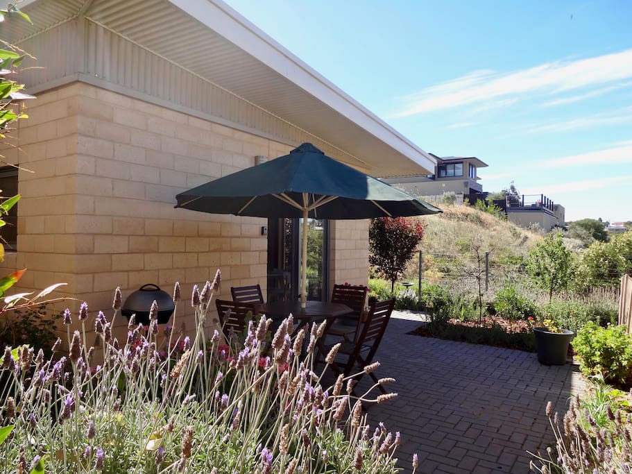 Separate private entry through courtyard showing outdoor setting and barbecue