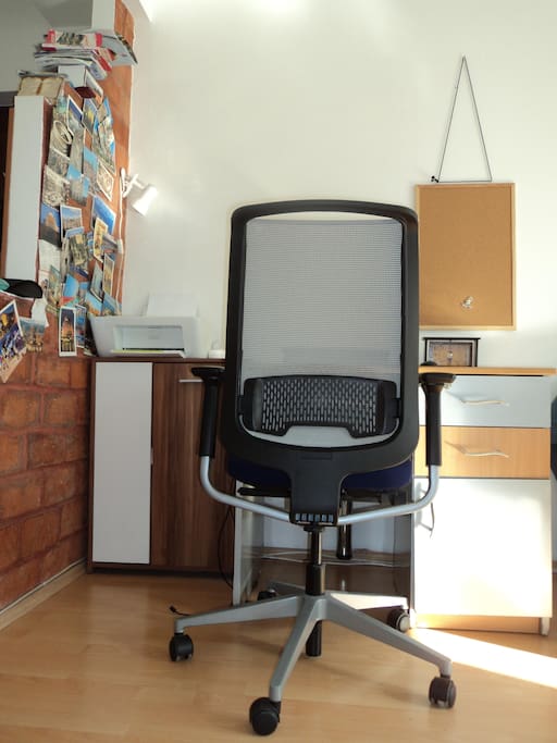 Working space, with printer. Quality chair for back support and ergonomic stay