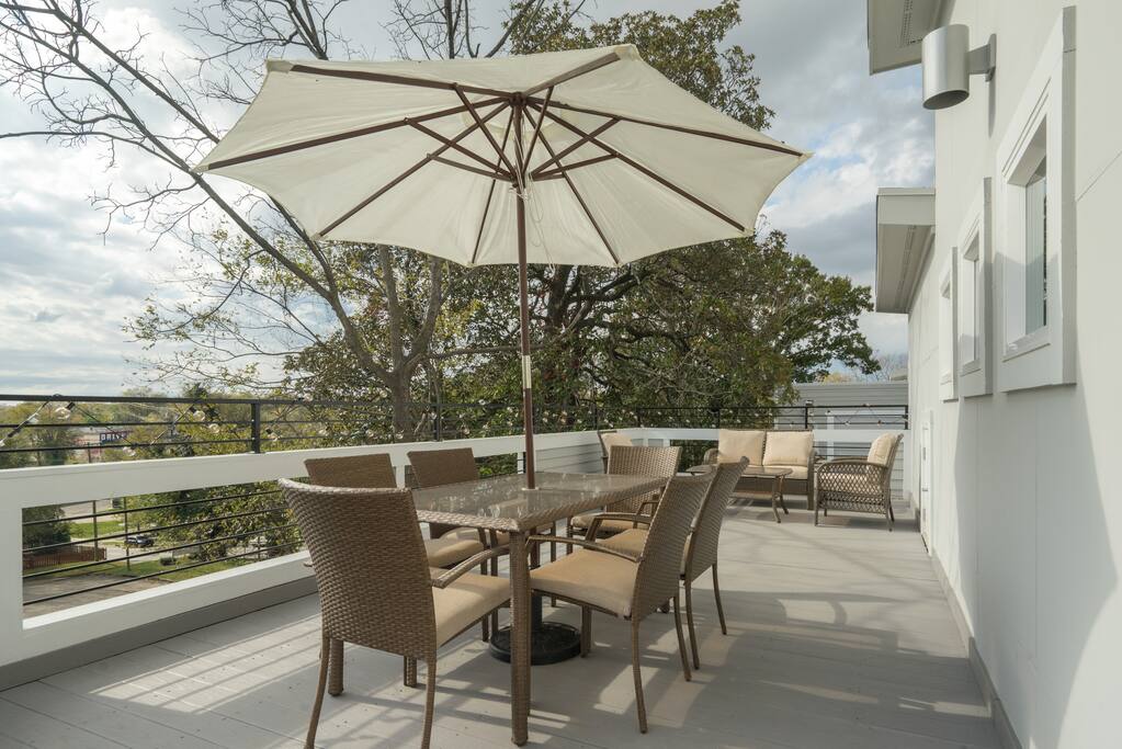 Seating for 10 on the private roof deck with al fresco dining and wicker sitting area.