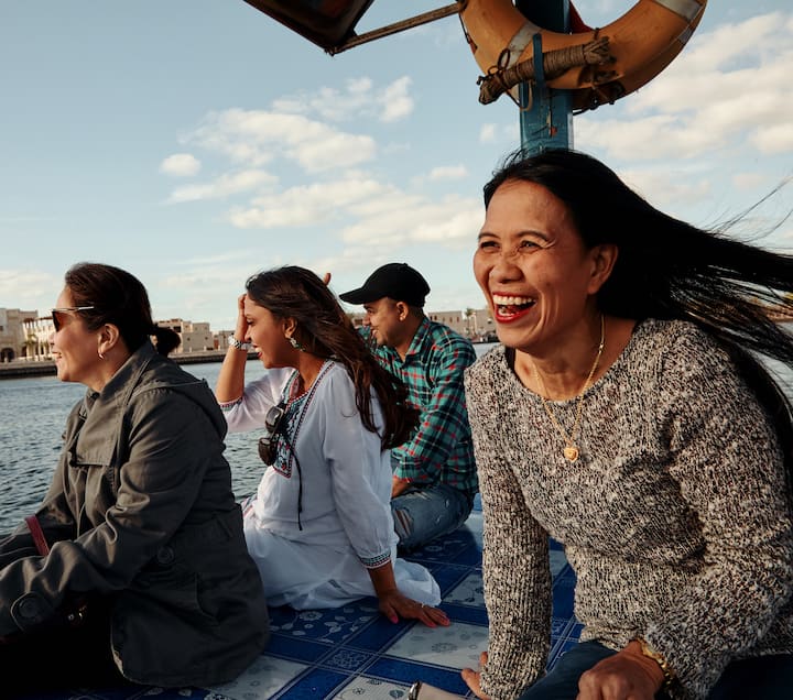 image of people smiling near the water