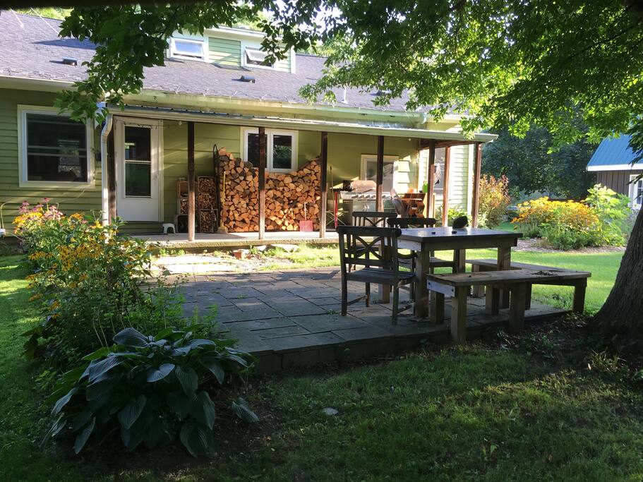 A built in table rests under the shade of a box elder tree.