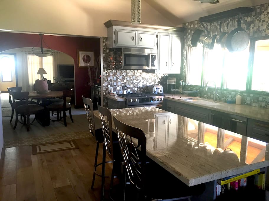 Kitchen to dining room to living room to entrance view