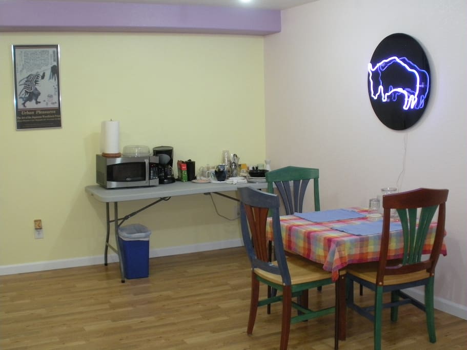Dining area with amenities table and neon light