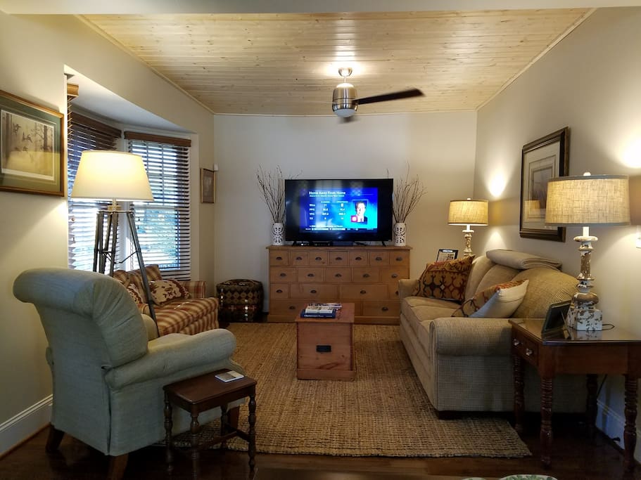 The den features a wood planked ceiling, oversized ceiling fan, and a 60" HD Smart Television. The sleeper sofa offers a queen sized 8" thick inflatable mattress with memory foam top. The room is the perfect gather place for everyone to relax and enjoy their visit.