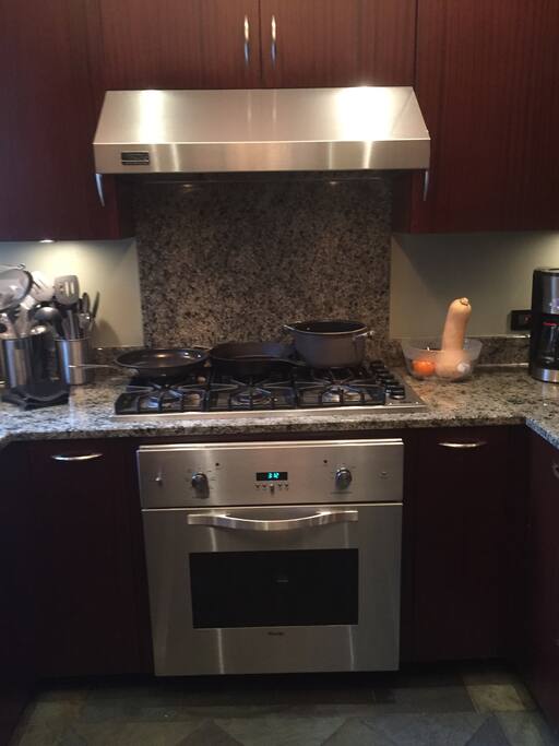 Viking range with 6 burners and convection oven. Lots of Chefs cookware to create a great meal.