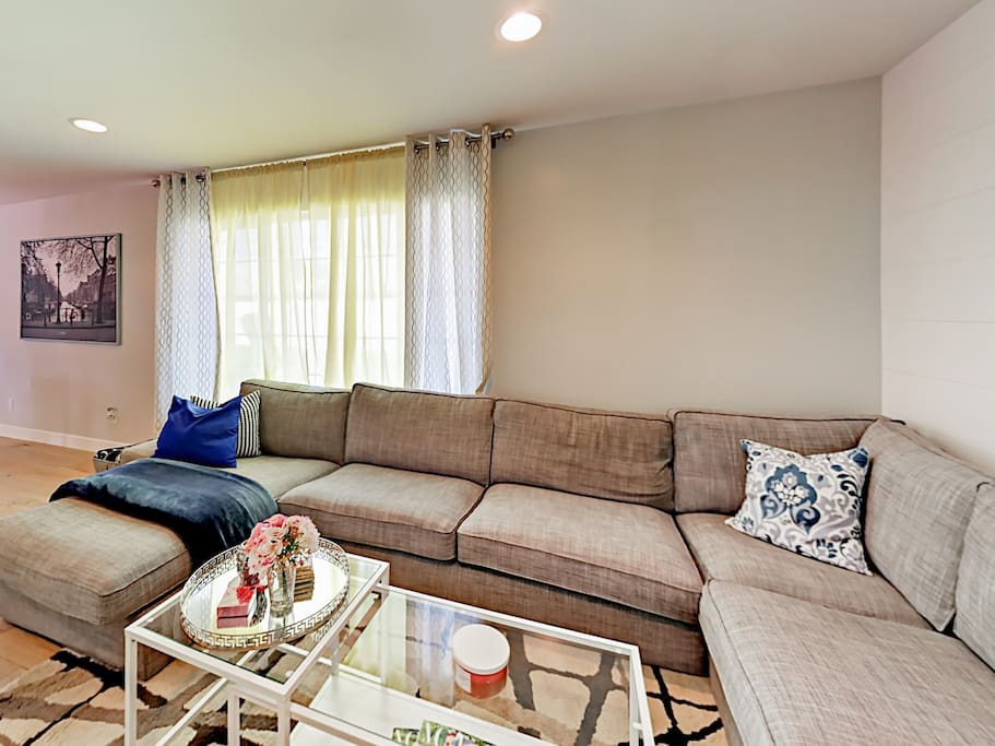 Light, bright and inviting - the large sectional is ideal for cozy nights in!