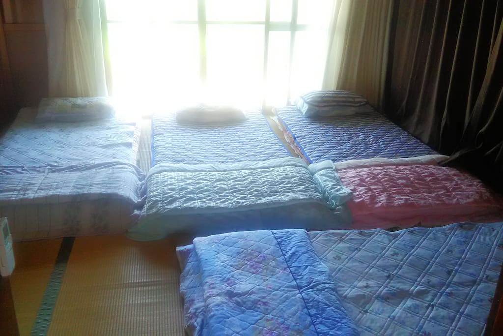 Large sunny room with 4 futon beds made up, Can prepare 5 single futons or 1 double and 3 singles