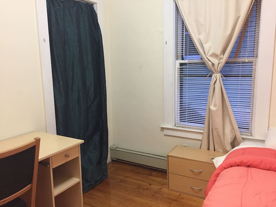Desk and closet behind the green curtain