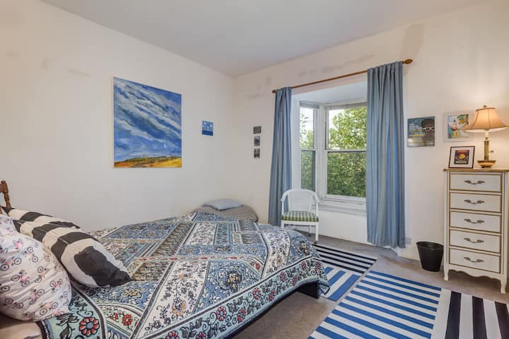 Back bedroom. Queen bed from Tuft and Needle. Very comfortable.  Bay window opens to the tree filled backyard. Futon bed shown in corner, very comfortable bed that can be rolled out for another guest.