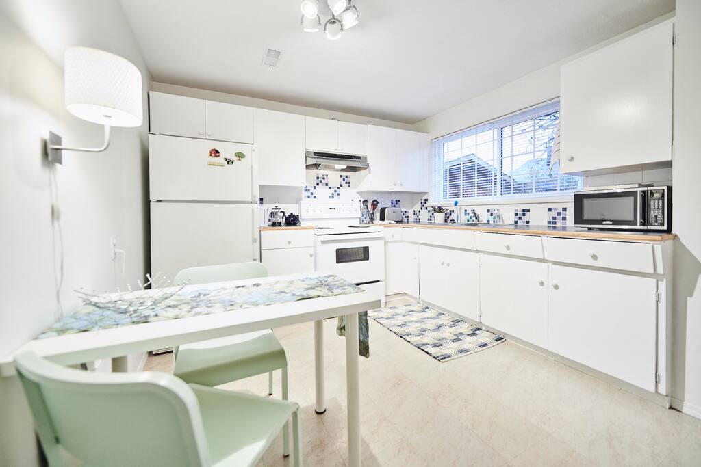 Fully stocked kitchen. Microwave, electric kettle, french press and traditional coffee maker, toaster, oven, stove top, pots, pans, dishes, knives and cutting boards. - Photo credit: Adam Blasberg Photography