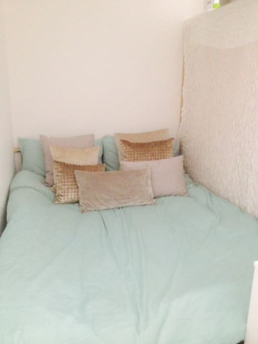 Cosy bed area dressed in bespoke scattered cushion which you can spread around and create a cosy sitting for two