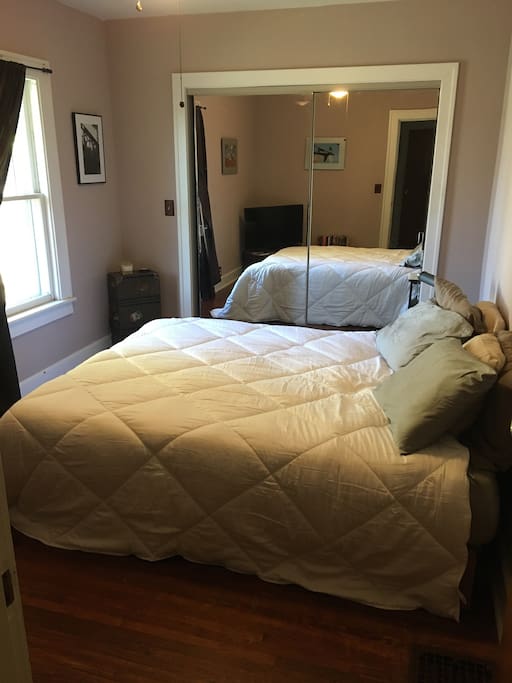 moderately sized room with large closet and dresser, queen memory foam bed, TV and DVD.