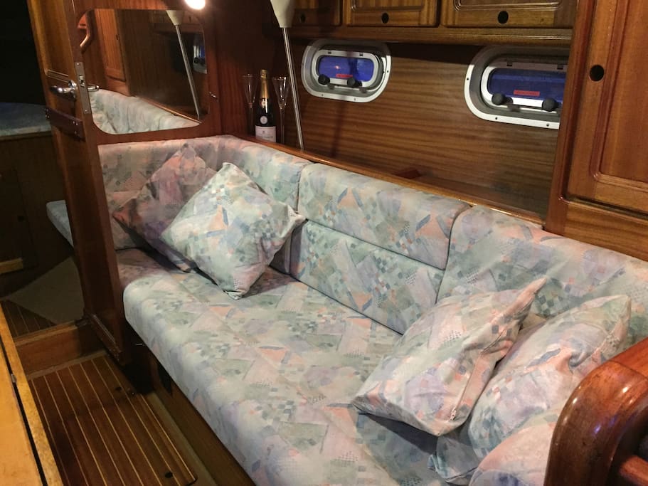 Saloon with fold down teak table. New cushions/covers throughout