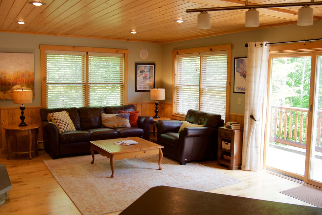 Bright spacious great room with leather furniture- stocked with board games and puzzles.