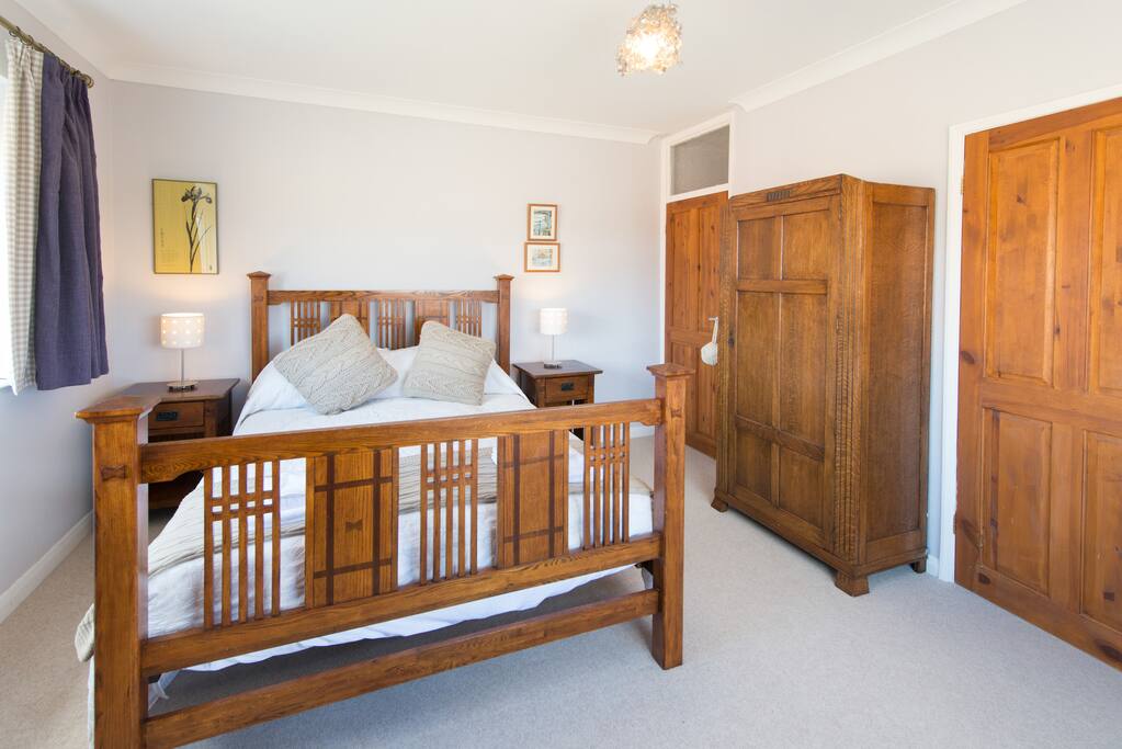 Master bedroom with king sized wooden 5ft bed and en suite shower room
