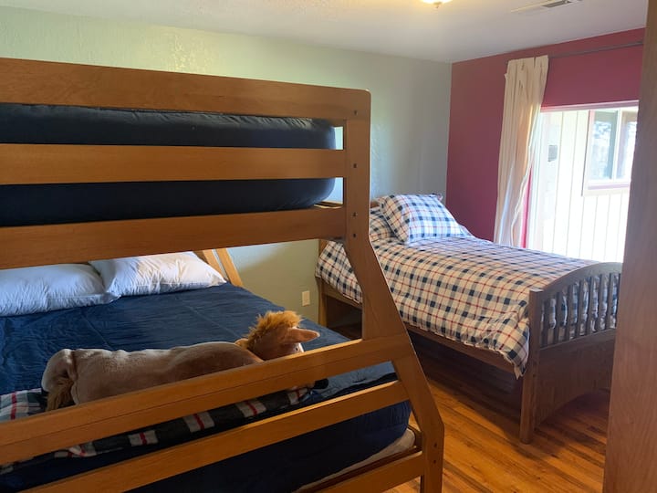 Bedroom 2 with a set of bunk beds- full on bottom, twin on top, plus one more twin bed.