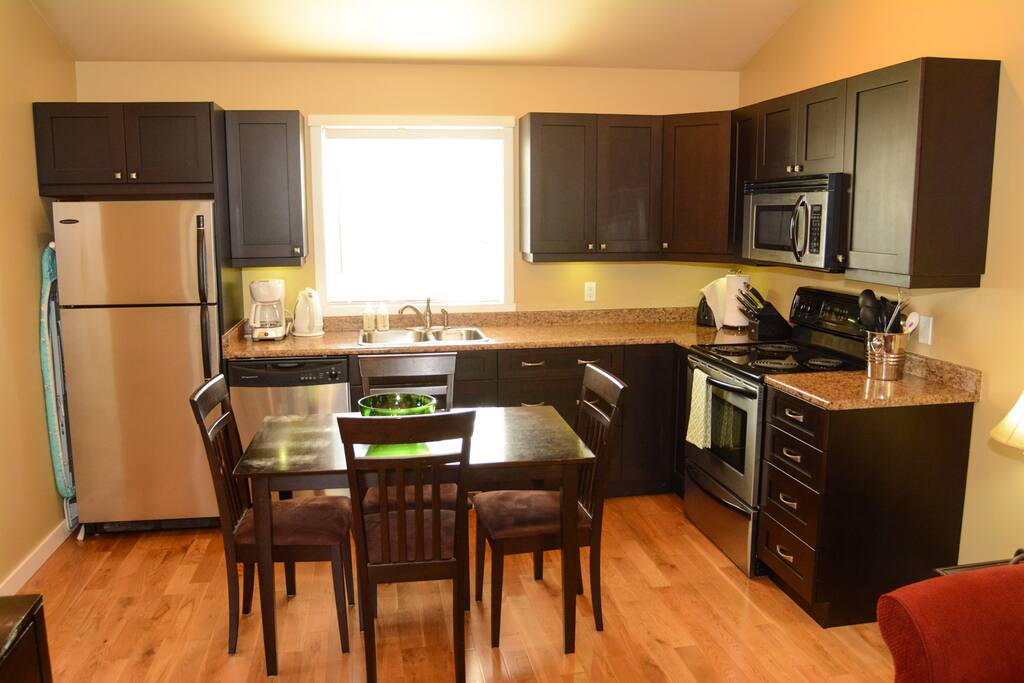 Full kitchen with fridge,dishwasher, microwave, and stove.