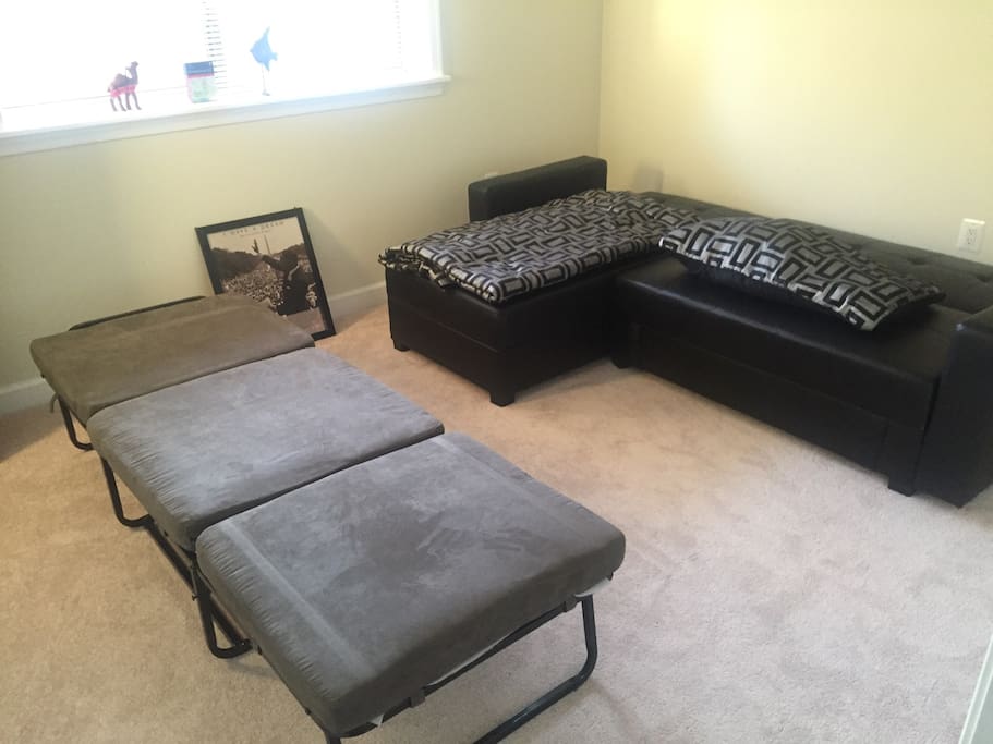 Sectional Sosa with storage underneath converts into sofa bed with two easy steps. Ottoman also converts into twin bed.