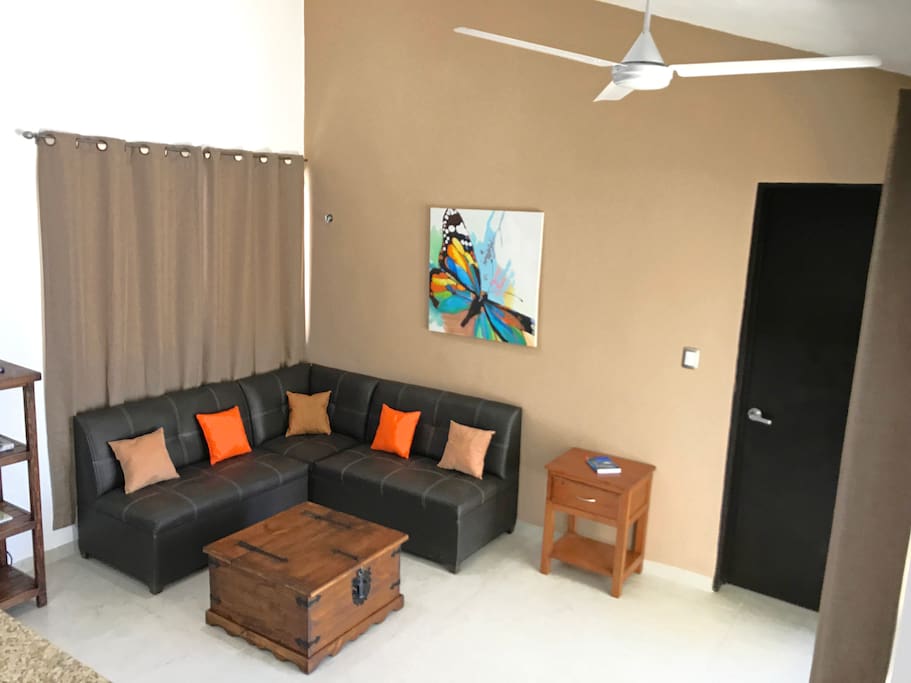 Living room is bright, with high ceilings + patio door access to yard & pool