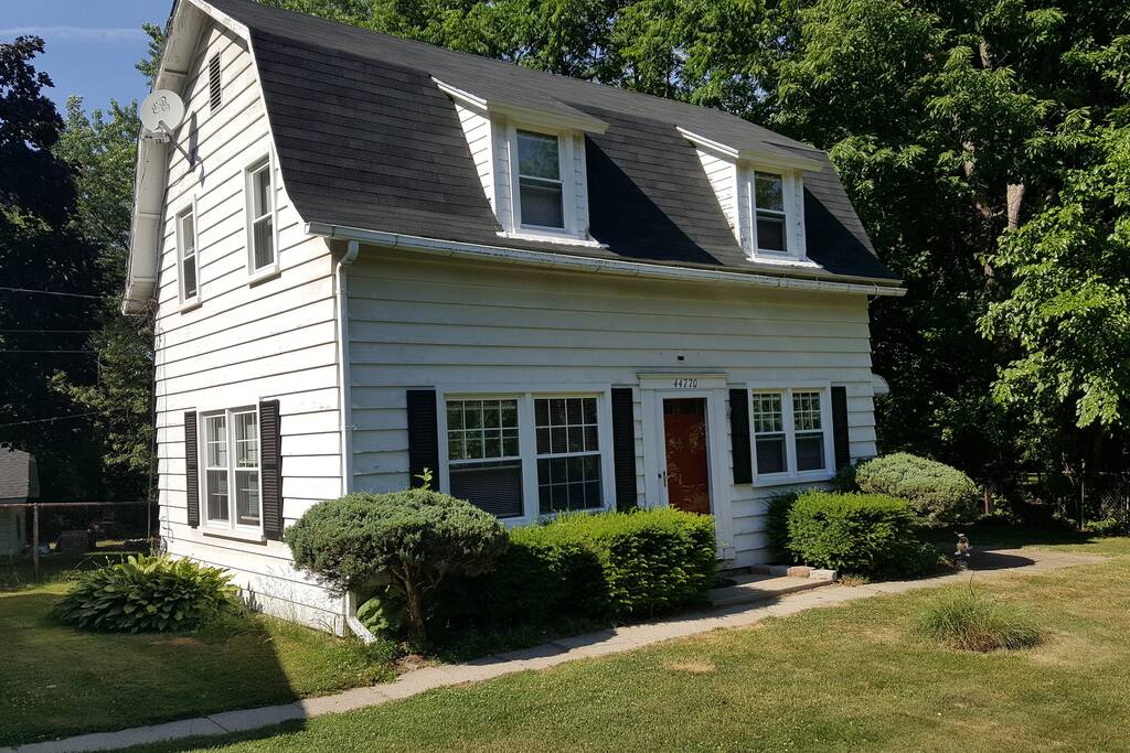 The main floor features a kitchen and living room with the bedrooms and bathroom on the upper floor.