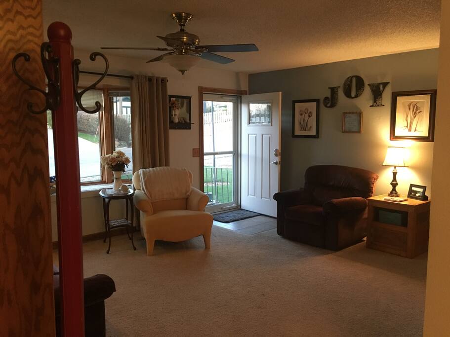 The front room is perfect to enjoy a warm cup of tea, with a couch and two chairs for seating.