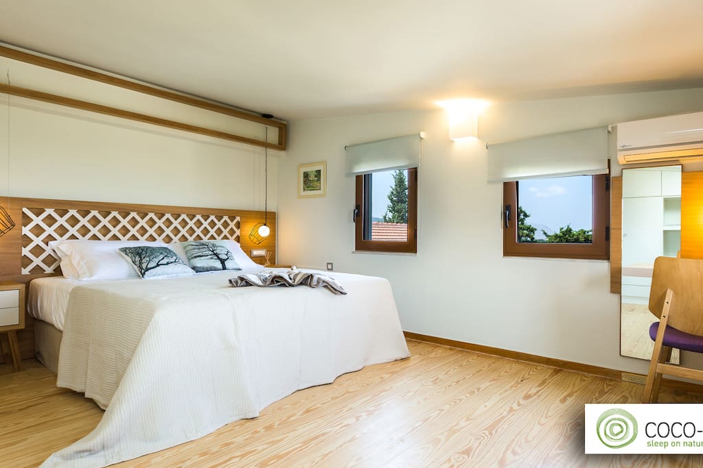 Master bedroom (1st floor): unique design of bed rest. Softwood floor from pitch pine