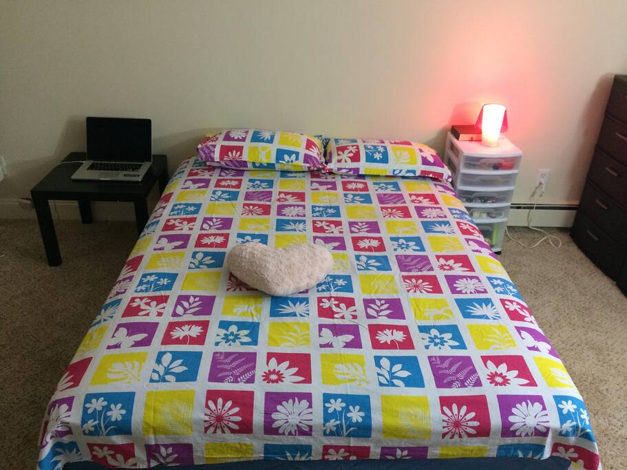 Queen size bed (two pillows) and a side table