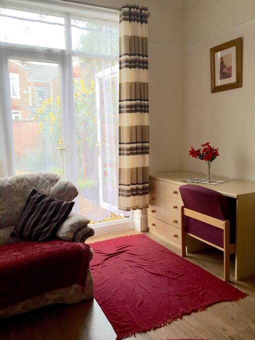 Writing desk by French window leading to sunflower garden.