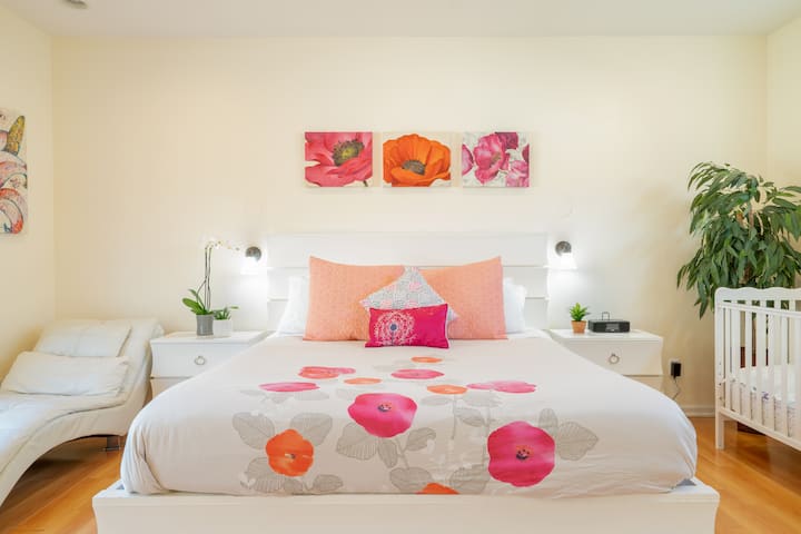 Master Bedroom with King size bed, TV, large closet, and full size crib for your little one's comfort