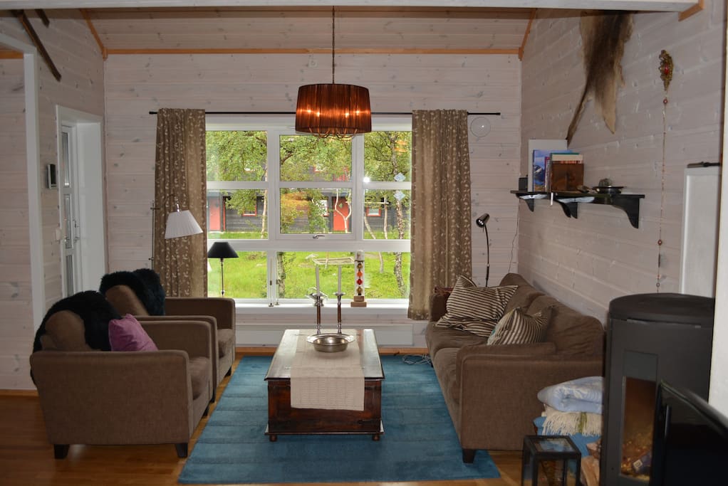 Cozy and comfortable lounge area with an open kitchen and dining section. There's a mezzanine above the sofas.
