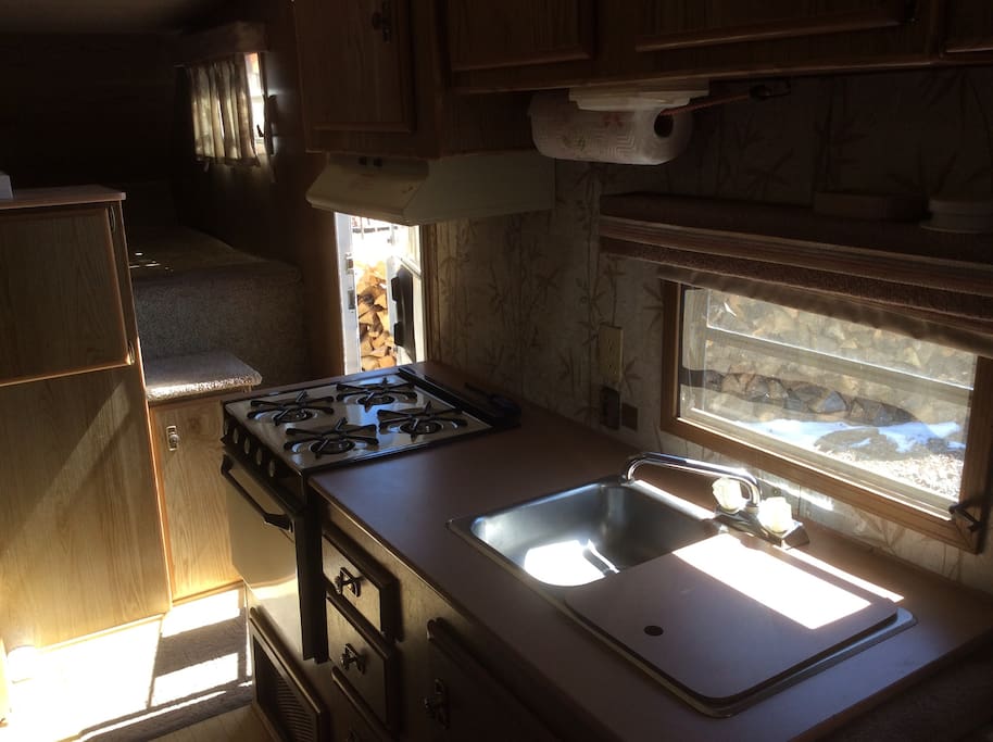 Oven, stove, refrigerator, freezer, double sink, all cooking and eating utensils.
