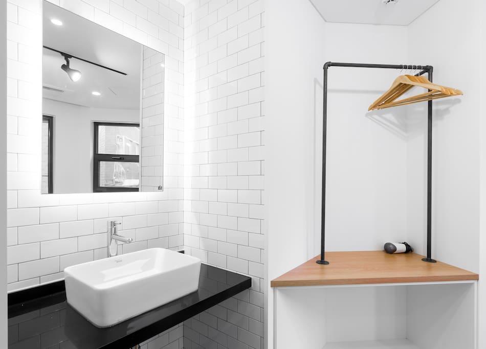 A separate washbasin with back-lit mirror and an open closet at the perfect height for suits or dresses are included in every room